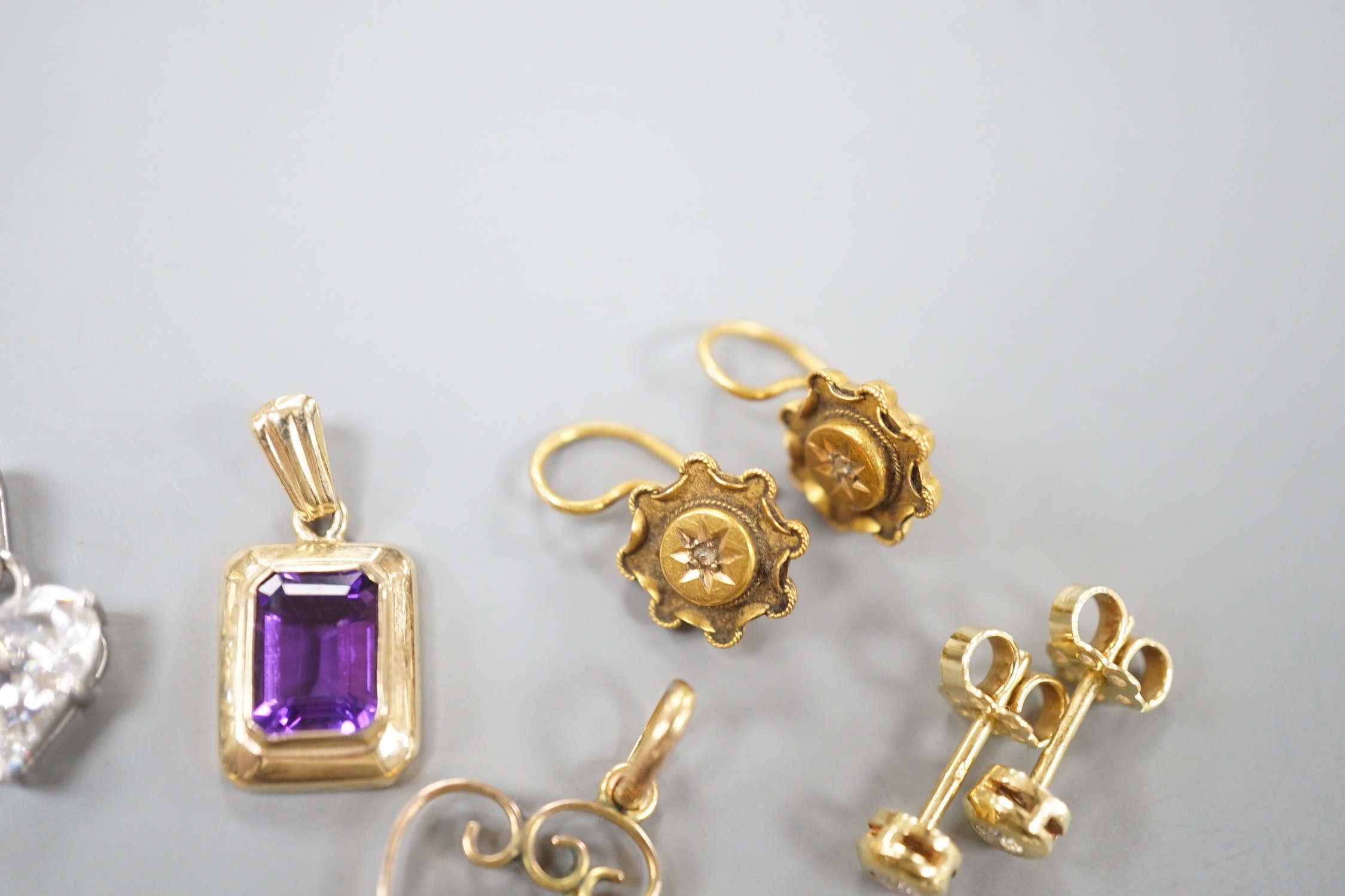 Mixed jewellery including a pair of Victorian 15ct and diamond chip earrings, a modern amethyst pendant, a garnet set yellow metal pendant, two pairs of 750 and diamond set ear studs, a pair of 750 white metal, tanzanite